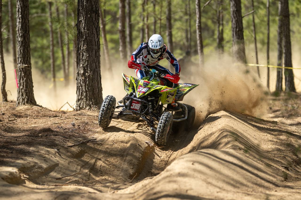 Rider cresting a sand jump on the GNCC course